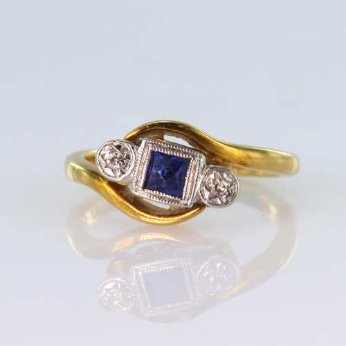 41 - 18ct yellow gold and platinum sapphire and diamond three stone ring in crossover design, total diamo... 
