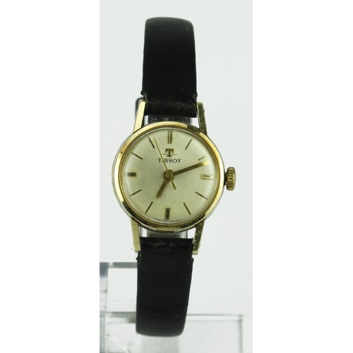 552 - Ladies 14ct cased Tissot wristwatch, on a leather strap. Watch working when catalogued
