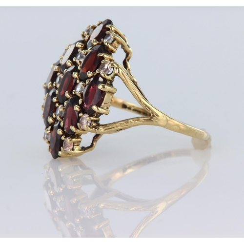 59 - 9ct yellow gold dress ring set with nine oval garnets spaced by round cz, finger size Q, weight 4.9g