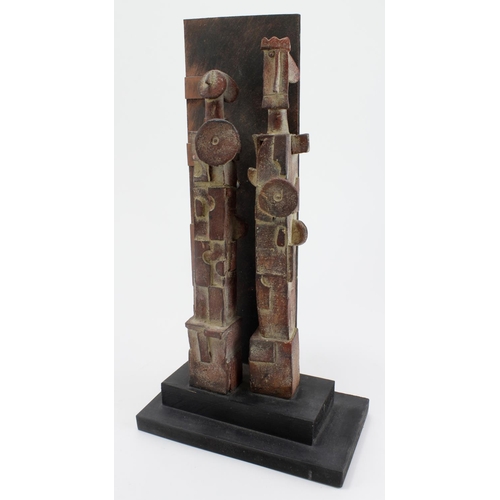 1114 - John Maltby (1936-2020). A stoneware sculpture, untitled, depicting two figures with a wooden wall b... 