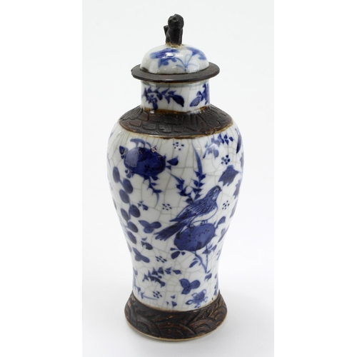 942 - Chinese blue & white vase, foo dog finial to lid, crackle glaze, Chinese characters to base, height ... 