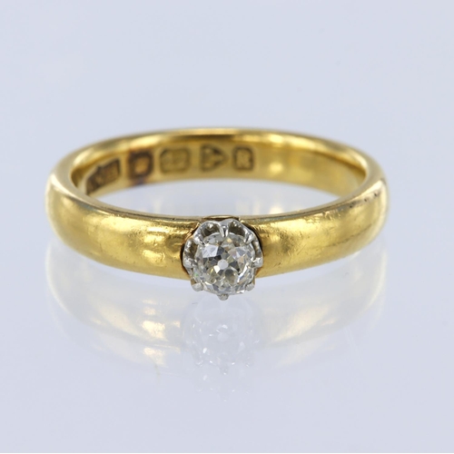 14 - 22ct yellow gold band ring with a white gold collet holding a single cushion shaped old cut diamond ... 