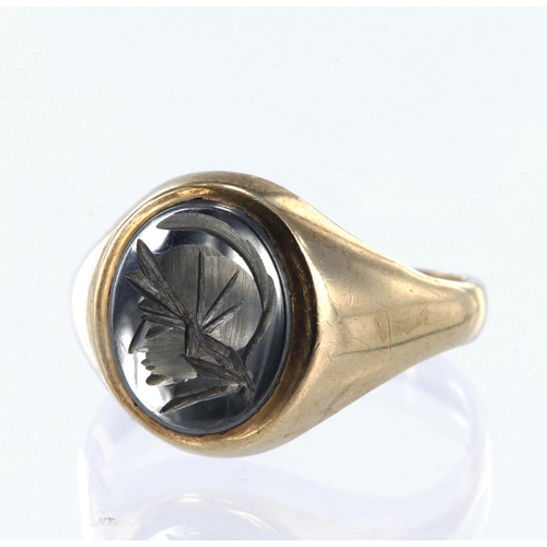 19 - 9ct yellow gold signet ring set with a carved oval haematite measuring approx. 12mm x 10mm, finger s... 