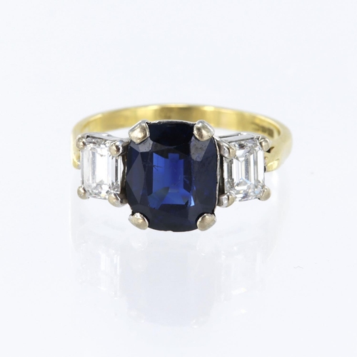22 - 18ct yellow gold trilogy ring, set with a cushion cut mid-blue sapphire measuring 10mm x 8mm total w... 