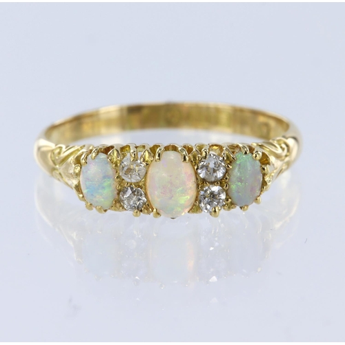 32 - 18ct yellow gold ring set with three graduated oval opal cabochons spaced by four round old cut diam... 