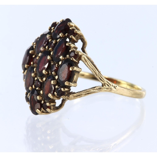 35 - 9ct yellow gold cluster ring, set with oval and round cut garnets, finger size V, weight 6.3g.