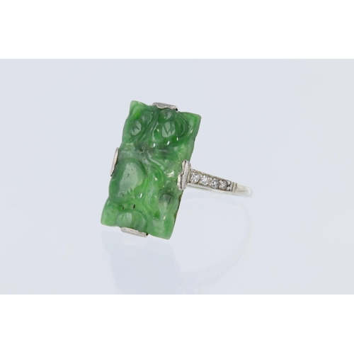 45 - Tests 9ct white gold ring, carved retangular jade , measuring approx 19mm x 10mm with supporting dia... 