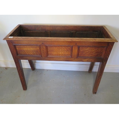 30A - An oak planter with three panel front, 72cm tall x 95cm x 34cm