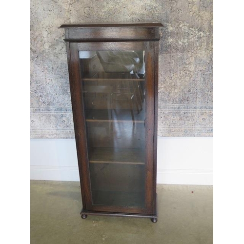 33A - A circa 1920s oak narrow glazed cabinet bookcase, 141cm tall x 61cm x 30cm