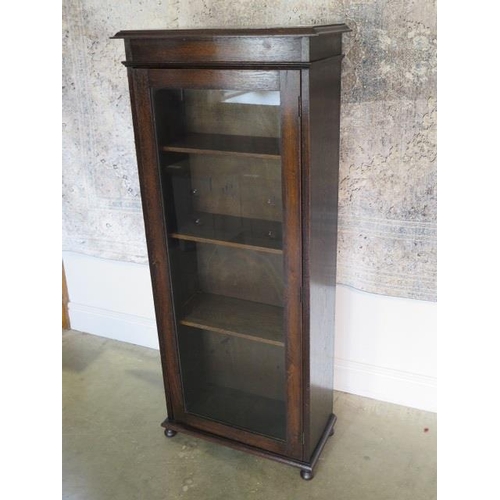 33A - A circa 1920s oak narrow glazed cabinet bookcase, 141cm tall x 61cm x 30cm