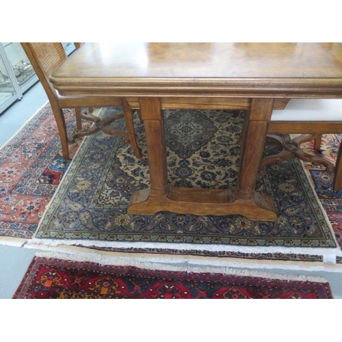 10A - A John Lewis oak and walnut extending two leaf dining table with six cane back chairs including two ... 