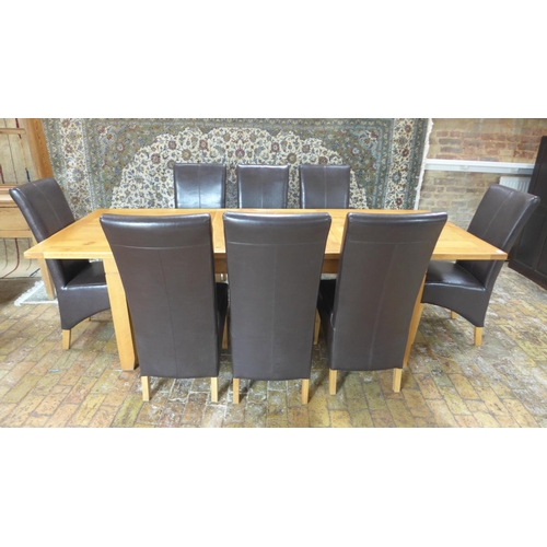 17 - A modern oak extending two leaf dining table and eight faux leather chairs - Table 75cm tall x 100cm... 
