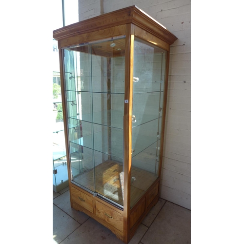 22 - A good quality wooden shop display cabinet with 2 sliding lockable doors, lighting, 3 adjustable she... 