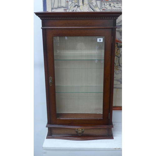 24 - A modern mahogany display cabinet with a base drawer and 2 x glass shelves.
85cm tall, 51cm x 20cm
