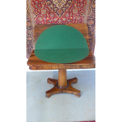 34 - A 19th century Rosewood fold over card table on a turned colomn and platform base. 92cm wide.