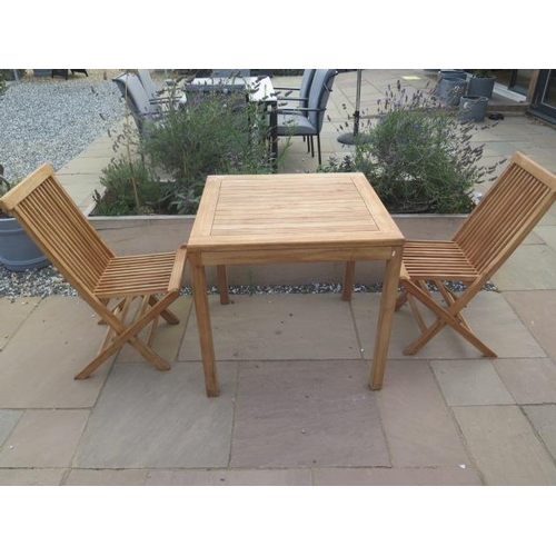 10 - A new boxed teak bistro table 70cm x 70cm and two folding dining chairs.