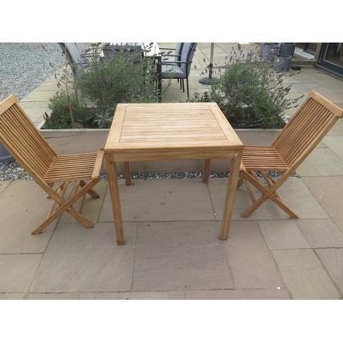 9 - A new boxed teak bistro table 70cm x 70cm and two folding dining chairs.