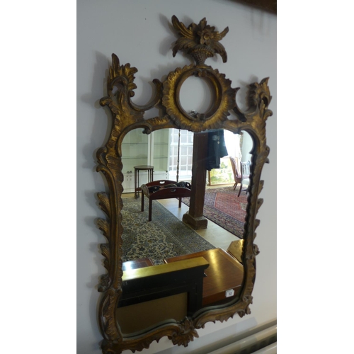 12 - An ornate gilt mirror 105cm x 57cm
