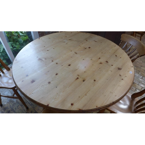 14 - A modern pine round dining table 74cm tall x 144cm and 5 chairs