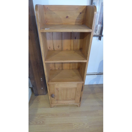 16 - A new pine bookcase with a base cupboard 110cm tall, 39 x 23cm