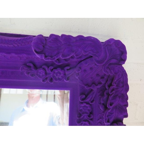 42 - An ornate purple fabric effect mirror, 176 cm x 90 cm