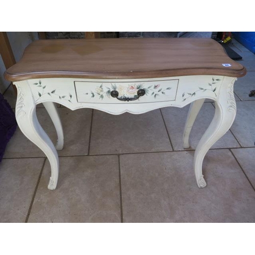 43 - A painted side table with a shaped top, 78 cm tall x 95 cm x 39 cm