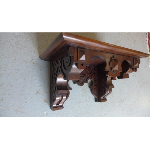 57 - A oak Gothic wall bracket shelf, 25cm tall x 43cm x 27cm