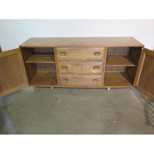 13 - An Ercol blond elm sideboard with 3 drawers and 2 cupboard doors, 67cm tall, 156cm x 43cm, in good c... 