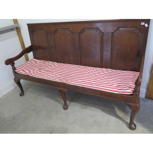 54 - A Georgian oak hall settle with a good patina and in sound condition, 183cm wide x 110cm tall x 64cm... 