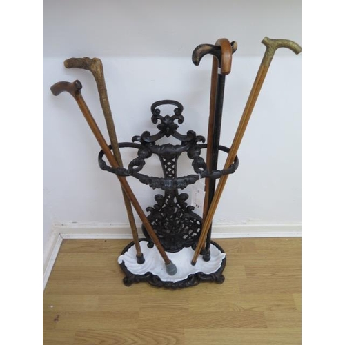 67 - A Victorian cast iron stick stand with 5 sticks, 72cm tall x 46cm wide