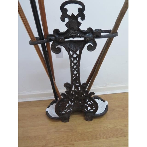 67 - A Victorian cast iron stick stand with 5 sticks, 72cm tall x 46cm wide