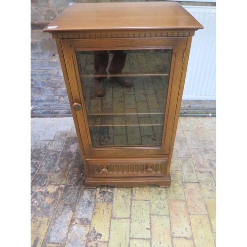 25 - An Ercol elm glazed cabinet and base drawer, 97cm tall x 56cm x 49cm, some usage marks but generally... 