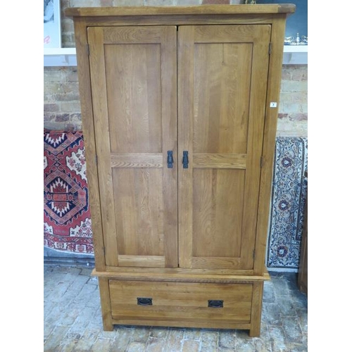 7 - An oak two door wardrobe with a single base drawer, comes in 2 parts, 193cm tall x 109cm x 58cm, gen... 