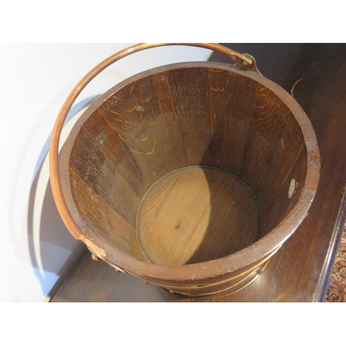 27 - A brass bound oak bucket planter, 45cm x 33cm diameter, in good condition