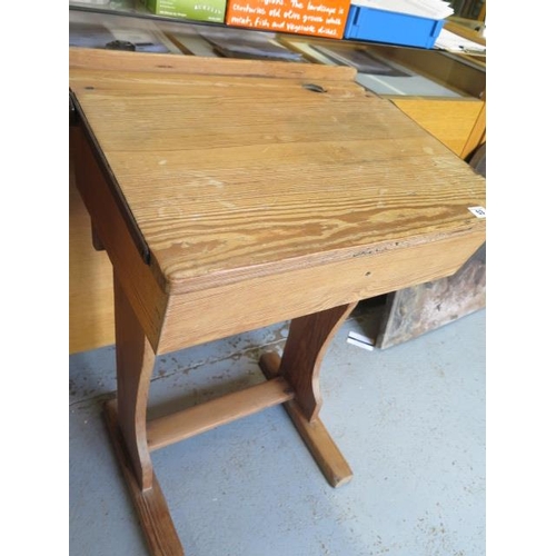 53 - A pitch pine school desk with hinged lid and inkwell recess, 81cm high, 58cm wide, 47cm deep, lackin... 