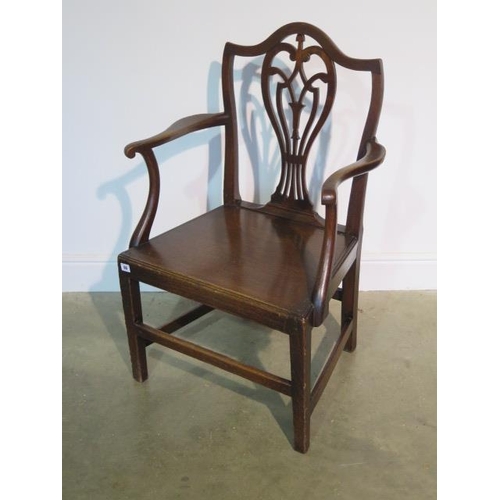 69 - A Georgian oak open armchair with solid seat, 98cm tall x 62cm wide