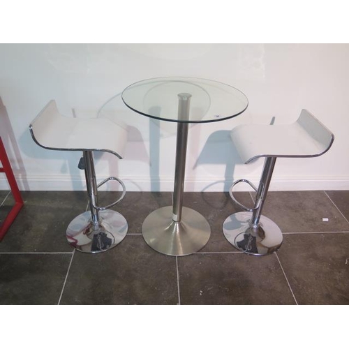 42 - A glass top bar table, 91cm tall x 60cm diameter with two white laminated gas lift stools, some usag... 