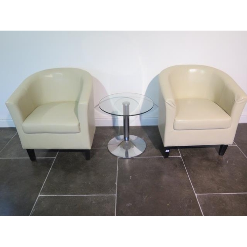 48 - A pair of faux leather cream tub chairs with a glass top coffee table, 49cm tall x 53cm, some usage ... 