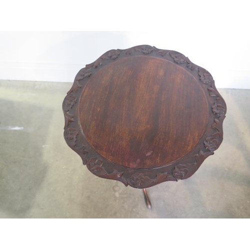 58 - A carved beechwood tilt top wine table with repairs, 59cm tall x 45cm wide