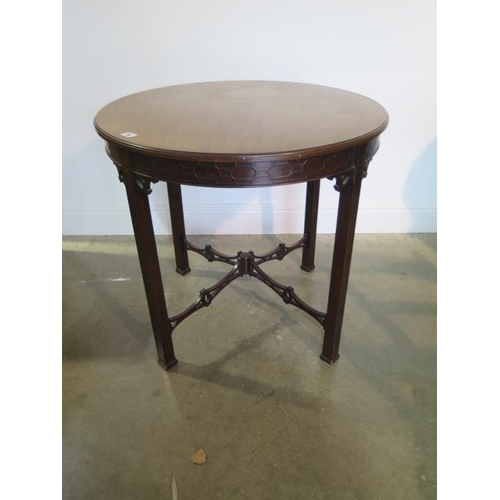 60 - An Edwardian mahogany circular window table with a carved frieze and fretted stretchers, 71cm tall x... 