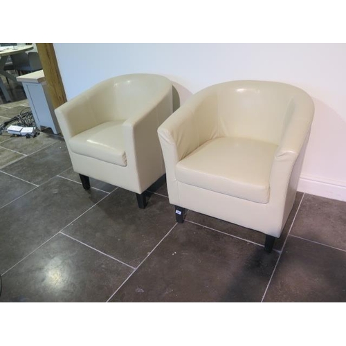 13 - A pair of faux leather cream tub chairs, some usage marks but generally good