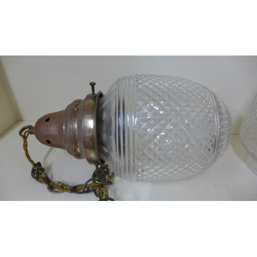 74 - A pair of cut glass hanging ceiling lights with brass holders, 38cm long x 20cm wide, both shades ha... 