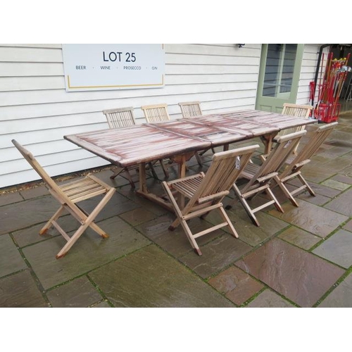 13 - A second hand teak garden table extends from 180cm to 296cm x 110cm wide with eight folding teak cha... 