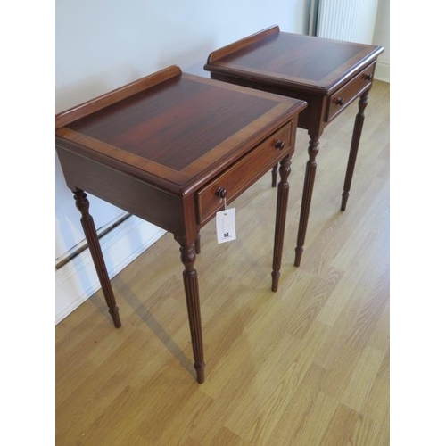 26 - A pair of crossband lamp tables with a single drawer on turned reeded legs made by a local craftsman... 