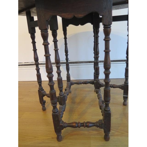 63 - A small oak gateleg table on finely turned supports - Height 66cm x 84cm x 72cm