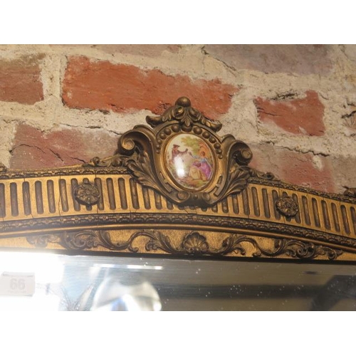 66 - A gilt wall mirror with porcelain plaque - some gesso losses and cracking to gesso but a decorative ... 