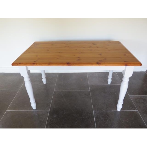 43 - A pine kitchen table with painted turned leg base - height 76cm x 137cm x 81cm