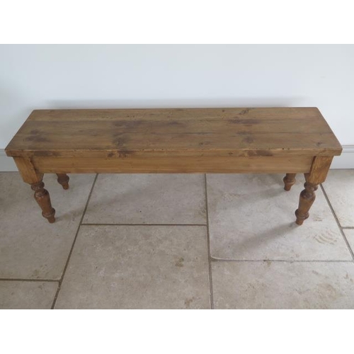 35 - A new rustic pine bench on turned legs, 46cm tall x 129cm x 32cm