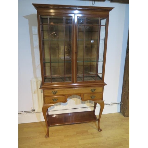 57 - A good quality mahogany glazed display cabinet with two doors over a frieze drawer and two small dra... 