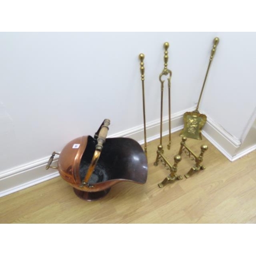 65 - A copper helmet coal scuttle with three brass fire irons and two rests - all in polished usable cond... 
